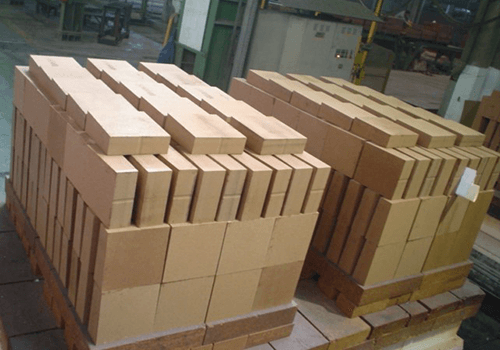 Bricks piled up on pallets in factory